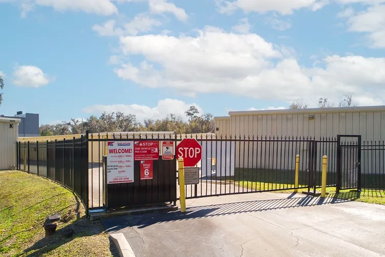 Secure gated storage facility entrance with keypad access and fencing